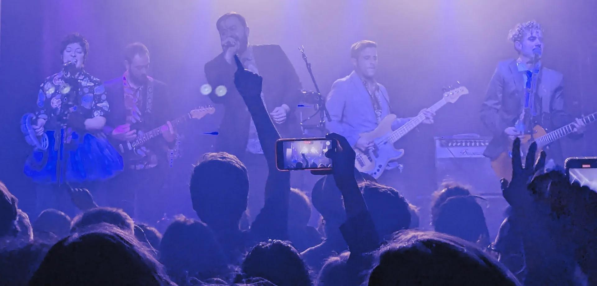 Efectiviwonders tocando en un concierto, vista frontal, con el público gritando